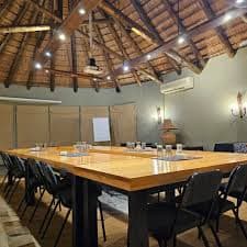 Executive boardroom at sunset over Victoria Falls region.